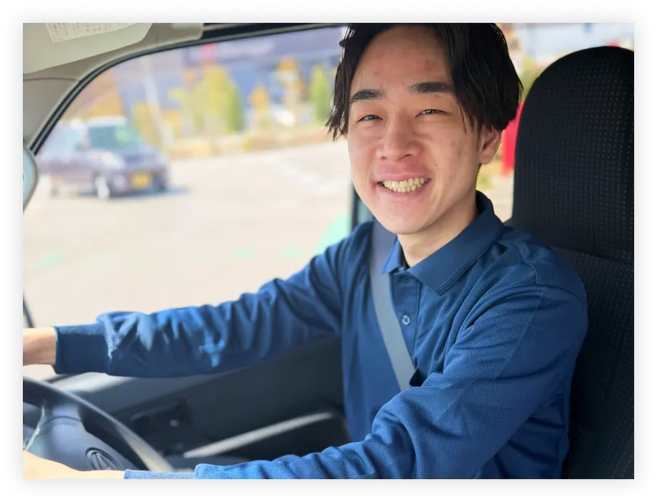 車内で笑顔の軽貨物ドライバー